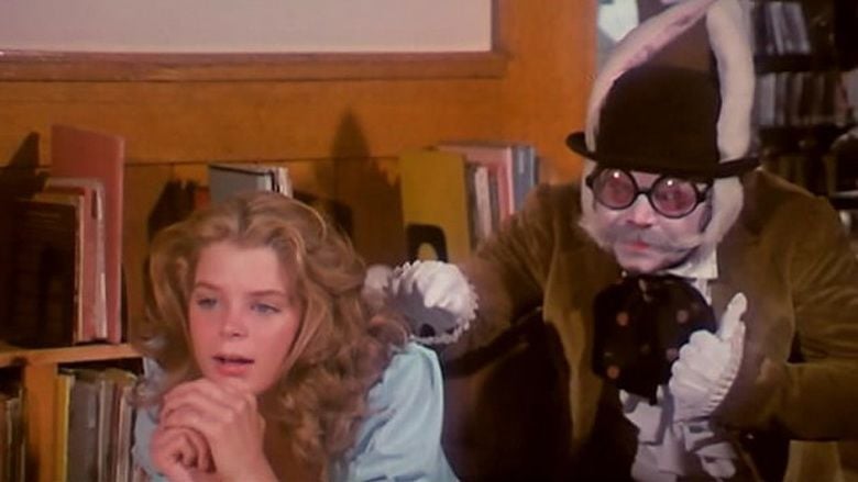 Larry Gelman tapping Kristine De Bell's shoulder in a scene from the 1976 American musical fantasy adult film, Alice in Wonderland