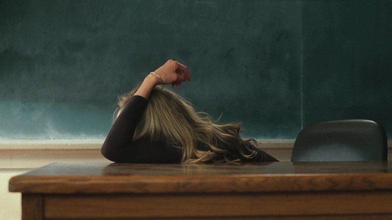 Cameron Diaz leaning on the table in a movie scene from Bad Teacher (2011 film)