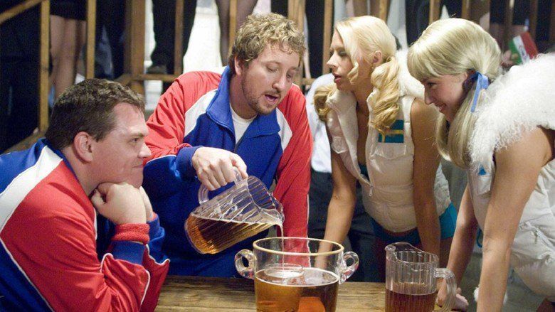 Paul Soter pouring a beer on the pitcher with Kevin Heffernan, Simona Fusco, and Jessica Williams in a movie scene from the 2006 film Beerfest