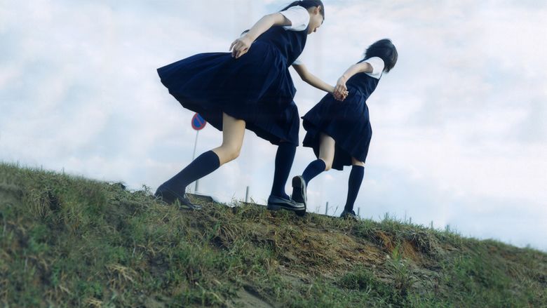 Mikako Ichikawa	as Kayako Kirishima and Manami Konishi as Masami Endo holding hands and wearing their school uniforms in a scene from Blue, a 2002 Japanese romantic drama.