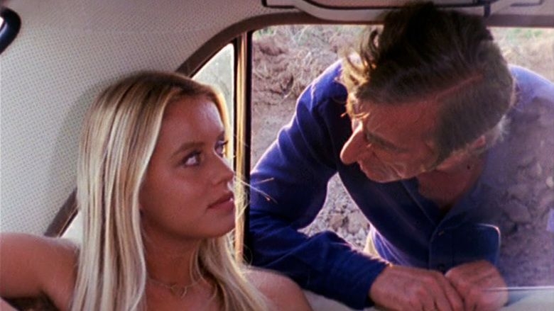 Gloria Guida as Daniela talking to Mario Pisu as Mauro inside a car in a scene from Blue Jeans,1975.