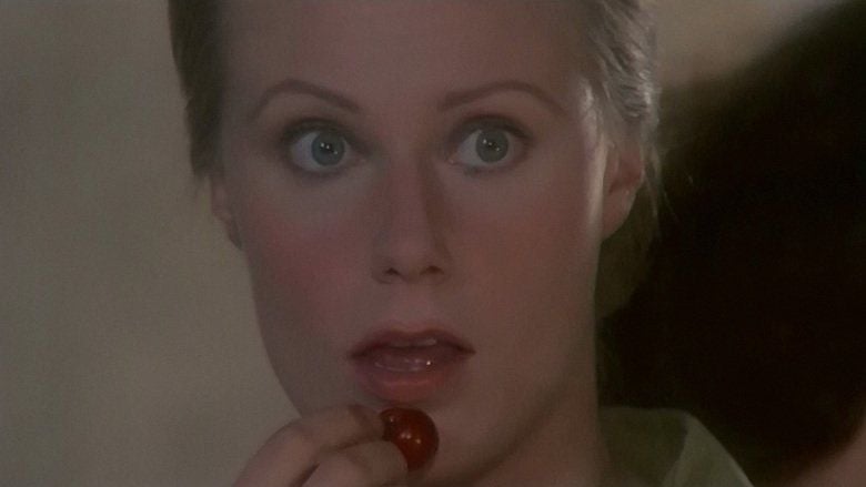 Nicola Warren as Jennifer looking at something with a surprised expression and about to eat a cherry in a scene from Capriccio, 1987.