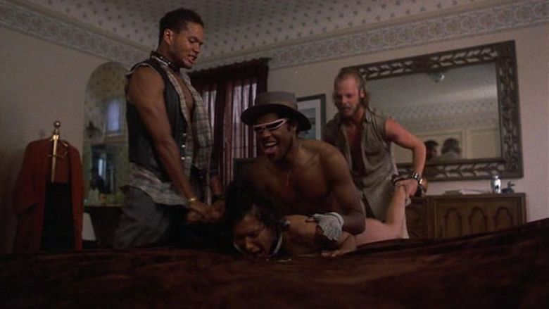 Silvana Gallardo as Rosaria being raped in a bedroom by Laurence Fishburne as Cutter and being held E. Lamont Johnson as Punkcut and Stuart K. Robinson as Jiver in a scene from the 1982 film "Death Wish II"