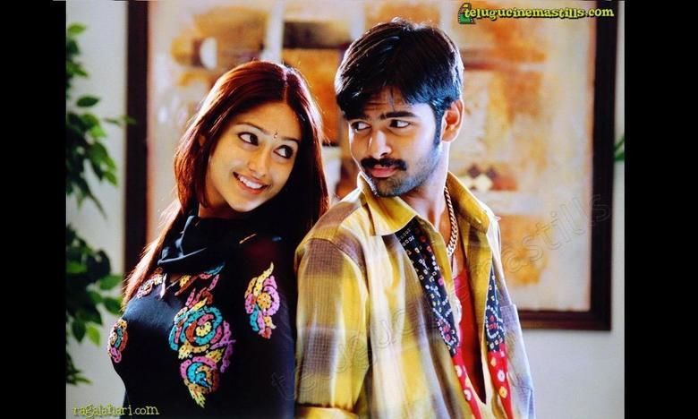 Ileana D'Cruz and Ram Pothineni are smiling while staring at each other in a scene from the 2006 Tollywood film, Devadasu