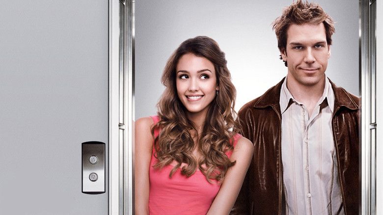 Jessica Alba and Dane Cook are smiling while Jessica is wearing a pink top and Dane is wearing a brown jacket and striped polo in the 2007 film, Good Luck Chuck