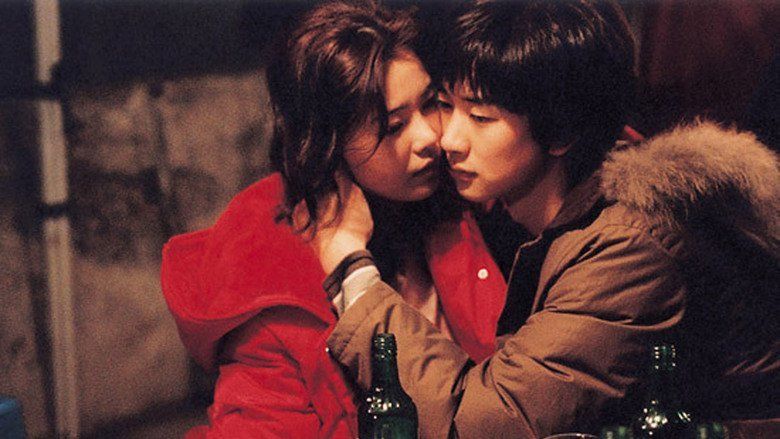 Shim Ji Ho holding Sung Juh by the neck with their faces close to each other in a scene from the 2005 film "Green Chair"