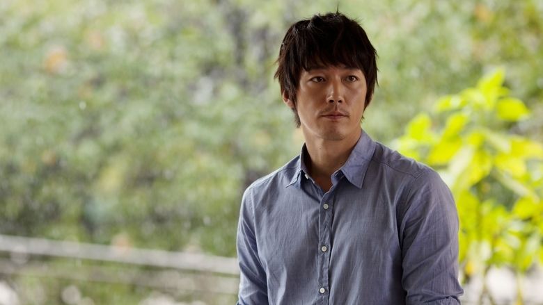 Jang Hyuk looking at something while wearing a blue long sleeve in a scene from the 2014 South Korean romantic thriller film, Innocent Thing
