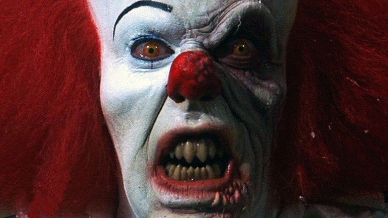Tim Curry as Pennywise, with an angry face in a scene from the 1990 psychological horror drama miniseries, It