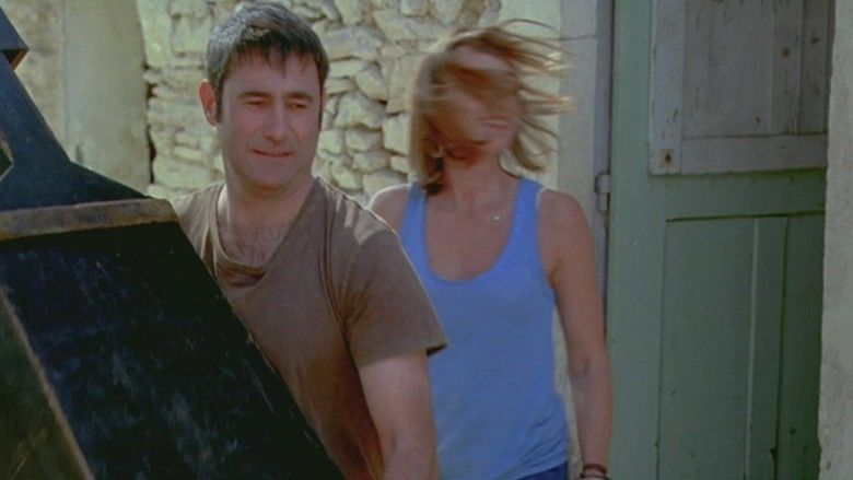 Leaving (2009 film) Kristin Scott Thomas wearing a blue sleeveless shirt and Sergi López wearing  a brown shirt (a movie scene)