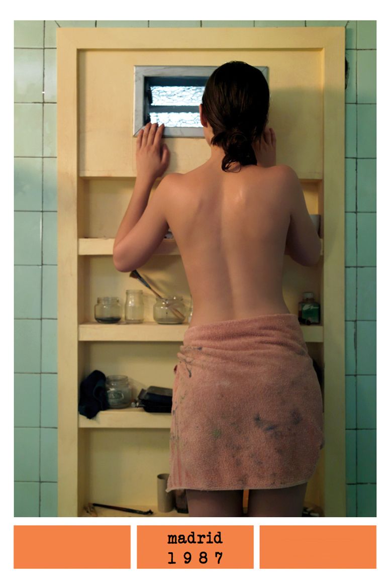 María Valverde looking at the window with a towel wrapped around her waist in the movie poster of the 2011 Spanish drama film, Madrid, 1987