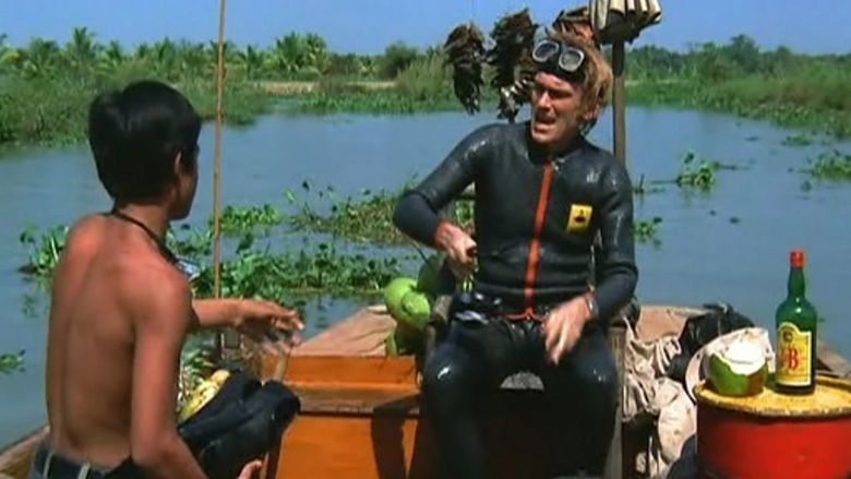 Ivan Rassimov riding in the boat in a movie scene from the 1972 film Man from the Deep River