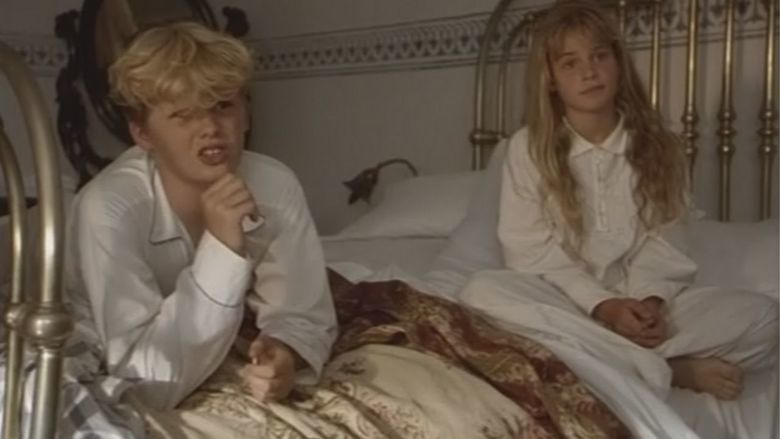 Nina Schweser and Jan Wachtel sitting on the bed in a movie scene from the 1994 film Mario and the Magician