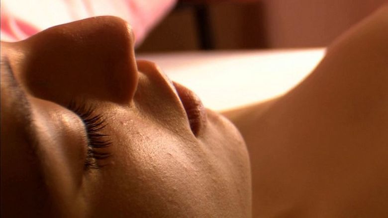 María Valverde lying down while her eyes are closed in a scene from the 2005 erotic drama film, Melissa P.