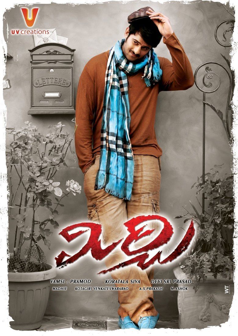Prabhas fixing his cap while wearing a brown sweatshirt, khaki pants, and blue checkered scarf in the movie poster of the 2013 film, Mirchi