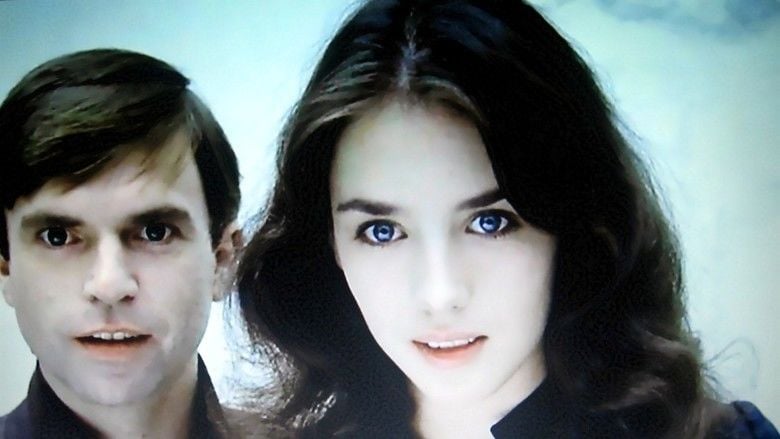 Sam Neill and Isabelle Adjani looking at something with excitement in a movie scene from the 1981 film, Possession