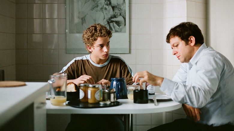 Jonas Bloquet as Jonas and Jonathan Zaccaï as Pierre talking and eating breakfast together in a scene from Private Lessons, 2008.