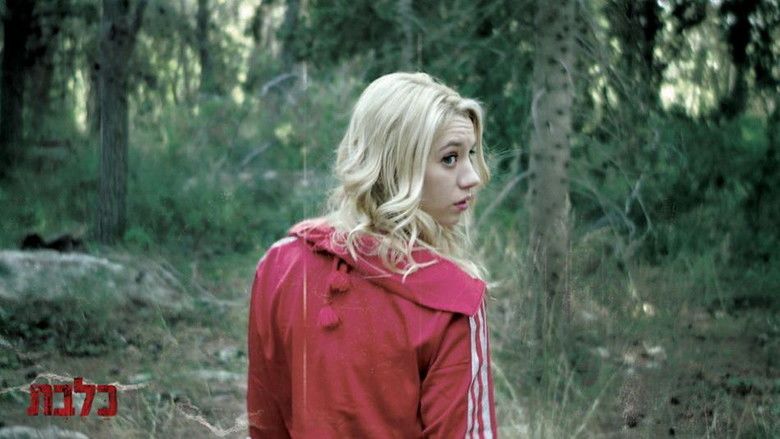 Yael Grobglas looking around while wearing a white and red jacket in a scene from the 2010 Israeli film, Rabies