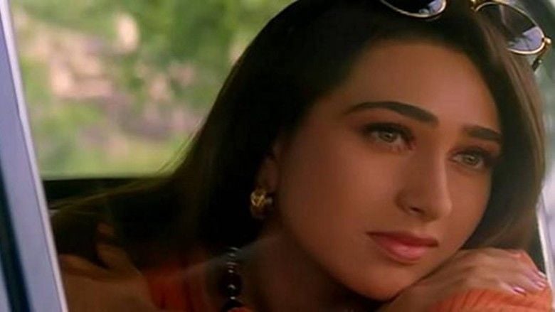 Movie scene from "Raja Hindustani"(1996) starring Karisma Kapoor as Aarti Sehgal wearing earrings and eyeglasses on her head