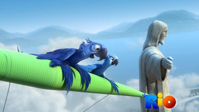 In the movie scene of Rio 2011, from left, Rio, a blue Spix's macaw is happy, looking down on top of a green pole high up above with clouds at the back and a statue at the right looking down arms wide open, hands open, has long hair wearing a long sleeve coat and scarf on his shoulder, has a black beak and blue body and feathers. At the right is Jewel, a female Spix's macaw. She is happy looking down on top of a green pole, has light blue body and feathers.