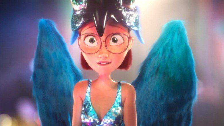 In the movie scene of Rio 2011, Linda is smiling, while standing in the middle, has short brown hair, wearing eyeglasses, a shiny blue dress, and a spix’s macaw costume on top of her head with blue wings.
