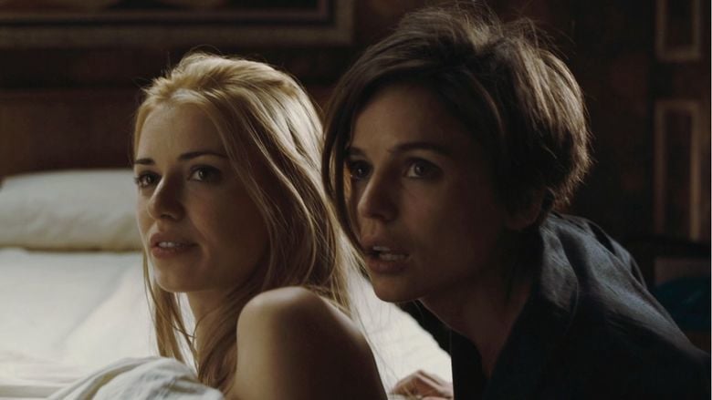 Elena Anaya as Alba and Natasha Yarovenko as Natasha looking at somwthing in a scene from Room in Rome, 2010.