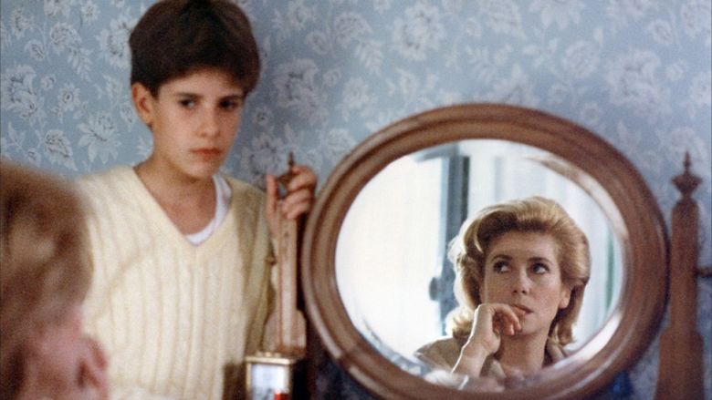 Nicholas Giraudi as Thomas and Catherine Deneuve as Lili looking at each other in a movie scene from Scene of the Crime (1986 film).