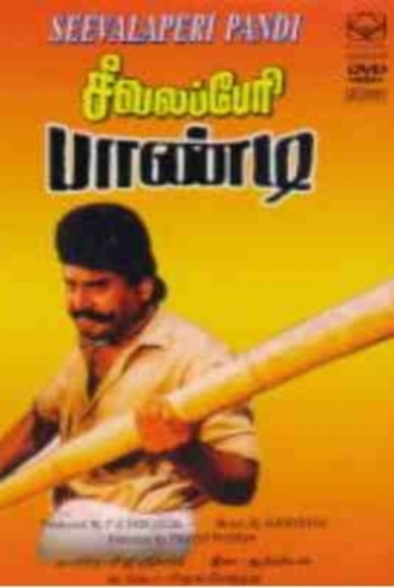 In the movie poster of Seevalaperi Pandi 1994, Napoleon is standing with a fierce look, holding a huge baseball bat, has a mustache and black hair wearing a yellow polo shirt.