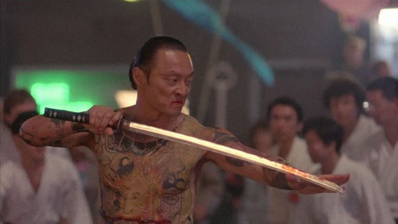 Cary-Hiroyuki Tagawa holding a sword with blood in a movie scene from the 1991 film Showdown in Little Tokyo