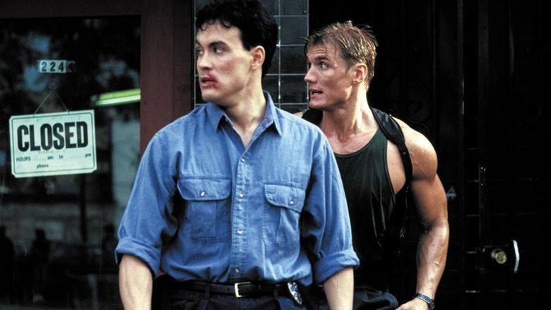Dolph Lundgren wearing a black sando and Brandon Lee wearing blue long sleeves in a movie scene from the 1991 film Showdown in Little Tokyo