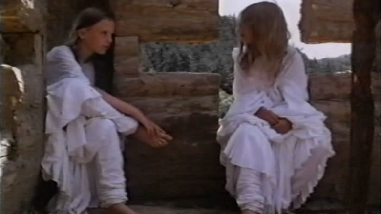 Two girls talking to each other while wearing a white dress in a movie scene from the 1984 film The Annunciation