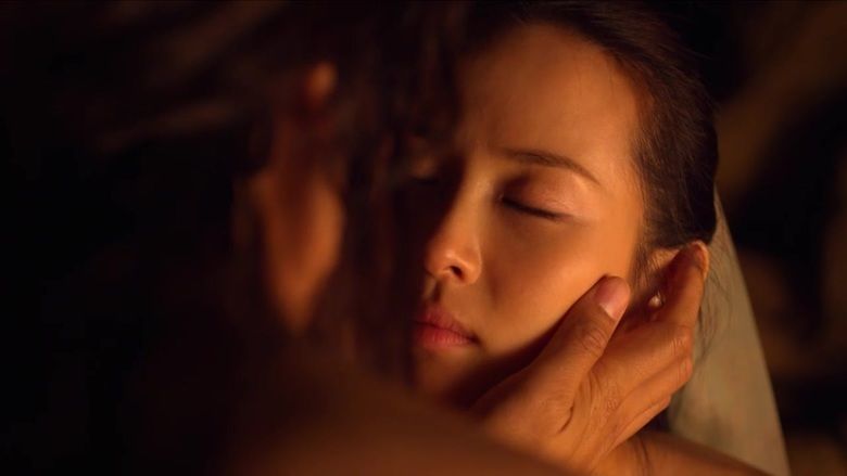 Jo Yeo-jeong as Shin Hwa-yeon with her faced being held by someone in a scene from the film The Concubine, 2012.
