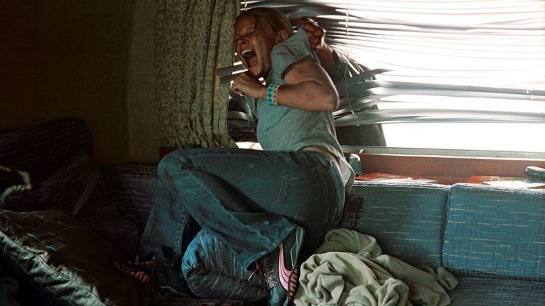 Emilie de Ravin screaming beside the window in a movie scene from the 2006 film The Hills Have Eyes