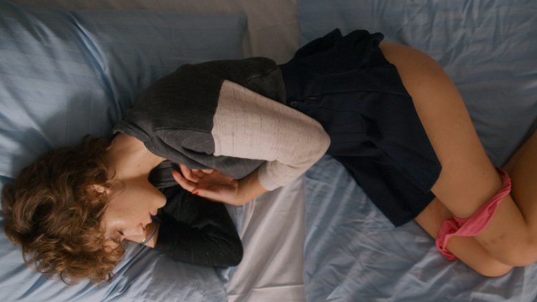 Carla Juri lying on the bed while her panty is on her legs in a scene from the 2013 German drama film, Wetlands