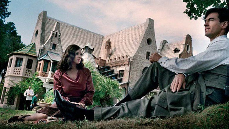 Monica Bellucci looking at Alessio Boni while sitting on the grass in a scene from the 2008 Italian film, Wild Blood (Sanguepazzo)