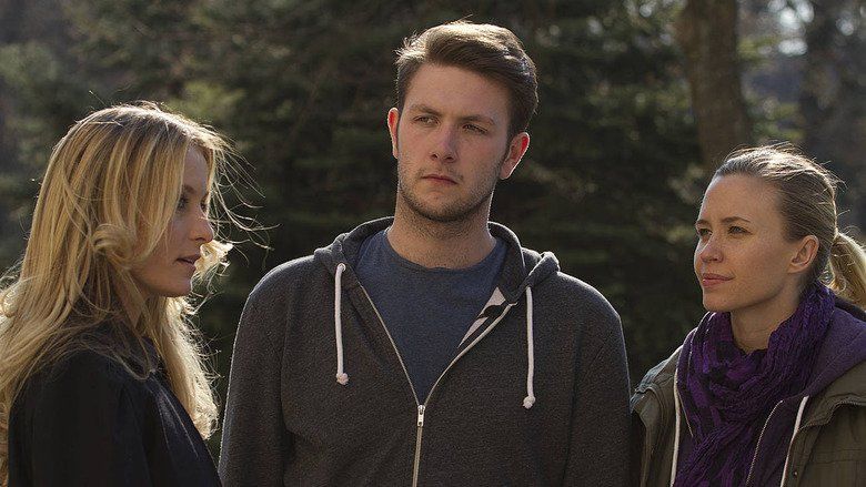 In the movie scene of Wrong turn 6 last Resort 2014, three people talking, from the left Sadie Katz is serious talking with Anthony Ilott (middle) and Aqueela Zoll (right), has long blond hair, in the middle, Anthony Ilott is serious, standing while looking at Sadie Katz, has brown hair wearing a blue shirt under his hoodie jacket, on the right, Aqueela Zoll smiling, looking at Sadie Ktaz has dark blond hair tied in a ponytail wearing violet wavy scarf and olive green jacket.