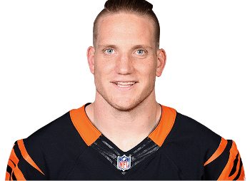 A J Hawk smiling has black hair, wearing an orange and black jersey