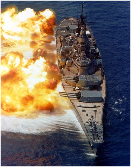 The battleship USS NEW JERSEY (BB-62) firing a full broadside to starboard during a main battery firing exercise in 1986