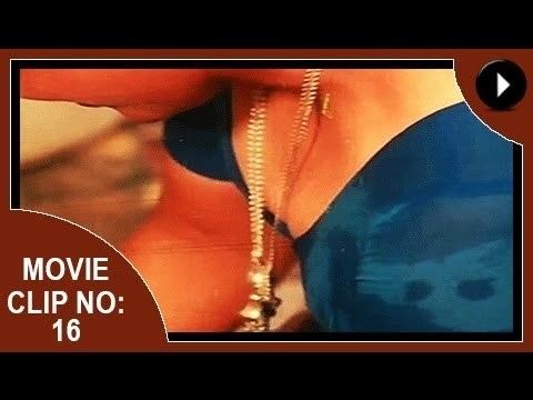 Movie clip no. 16 of Aadhi Thaalam, a 1990 Indian Malayalam film starring Jayarekha wearing a necklace and wearing a blue-green Indian dress.