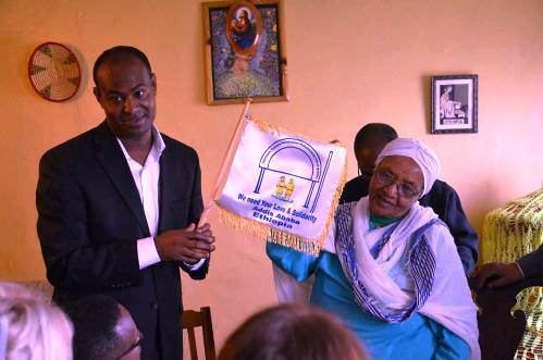 Abebech Gobena standing with a man holding a flag