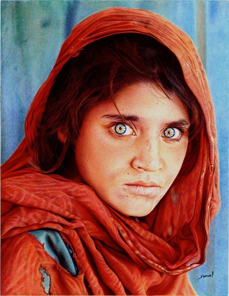 Afghan Girl, a 1984 photographic portrait of Sharbat Gula taken by photojournalist Steve McCurry, with green eyes staring directly into the camera, and wearing a red scarf draped loosely over her head.
