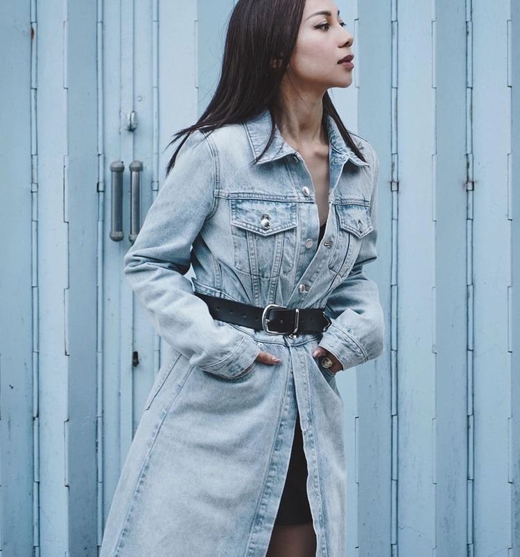 AGA looking afar while wearing a denim dress and black belt