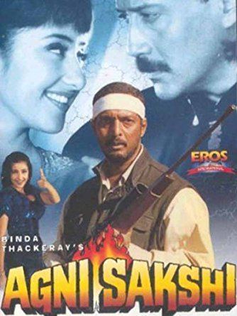 Nana Patekar holding a rifle and behind him are Manisha Koirala and Jackie Shroff in the movie poster of the 1996 film, Agni Sakshi