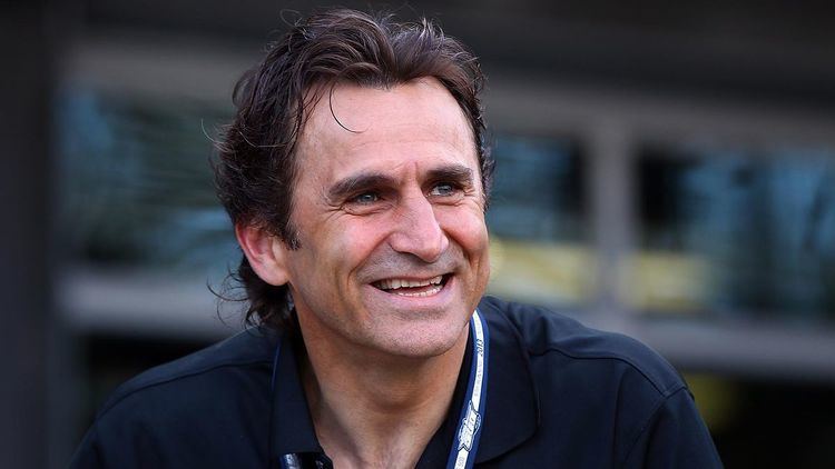 Alex Zanardi smiling while wearing black polo shirt