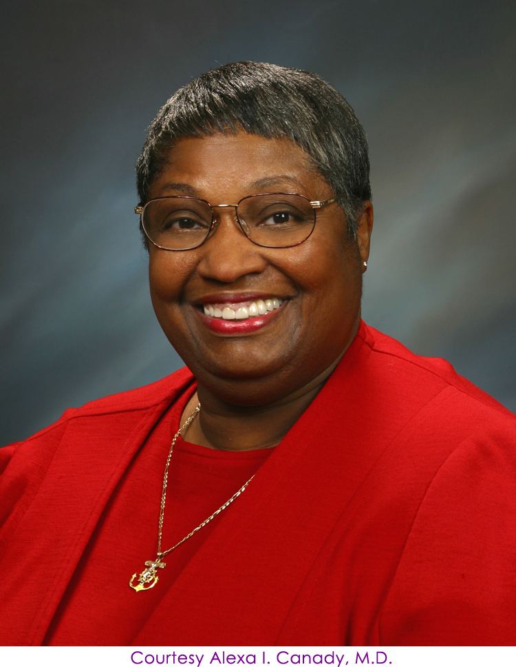 Alexa Canady smiling has short gray hair and wearing earrings, a gold necklace, eyeglasses, and a red blouse