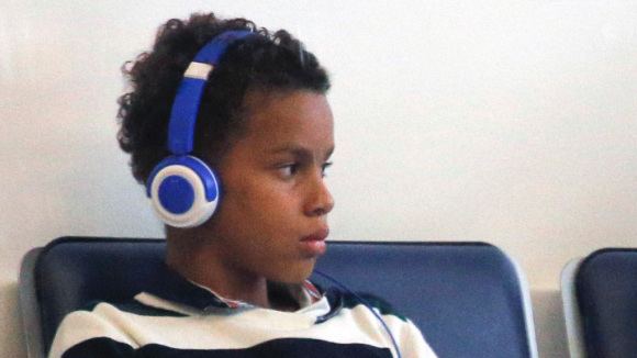 Alexandre Coste wearing a blue and white shirt with blue headphones on his head.