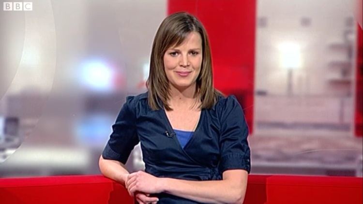 Alexis Green Alexis in her blue dress while sitting on a red couch