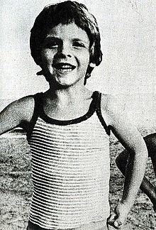 Alfredo Rampi with a smiling face and wearing a striped sando.