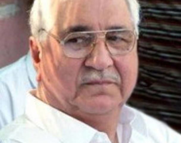 Ali Kuli Khan Khattak is serious, has white hair and a mustache, wearing eyeglasses and white long sleeves.
