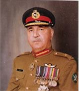 Ali Kuli Khan Khattak (General Ali Kuli) is serious, has a white mustache, and wears a black-red army hat, and a tan-colored uniform, with a pocket on the right and badges on left.