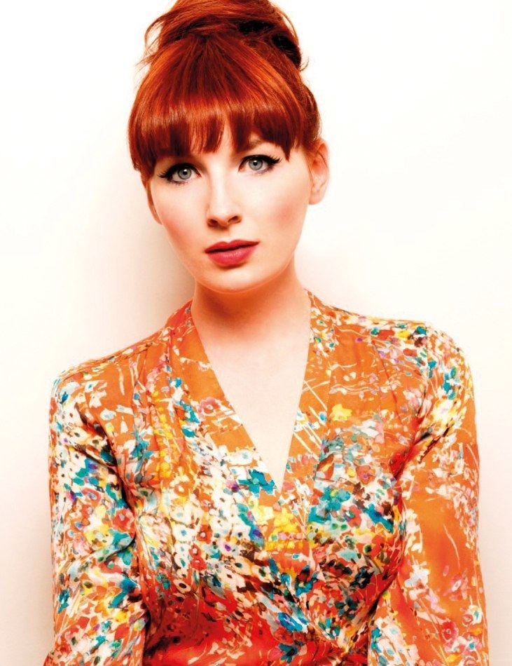 Alice Levine, on her fierce look, wearing an orange long-sleeved shirt